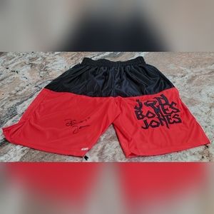 Jon Jones signed trunks with Bones inscription.
